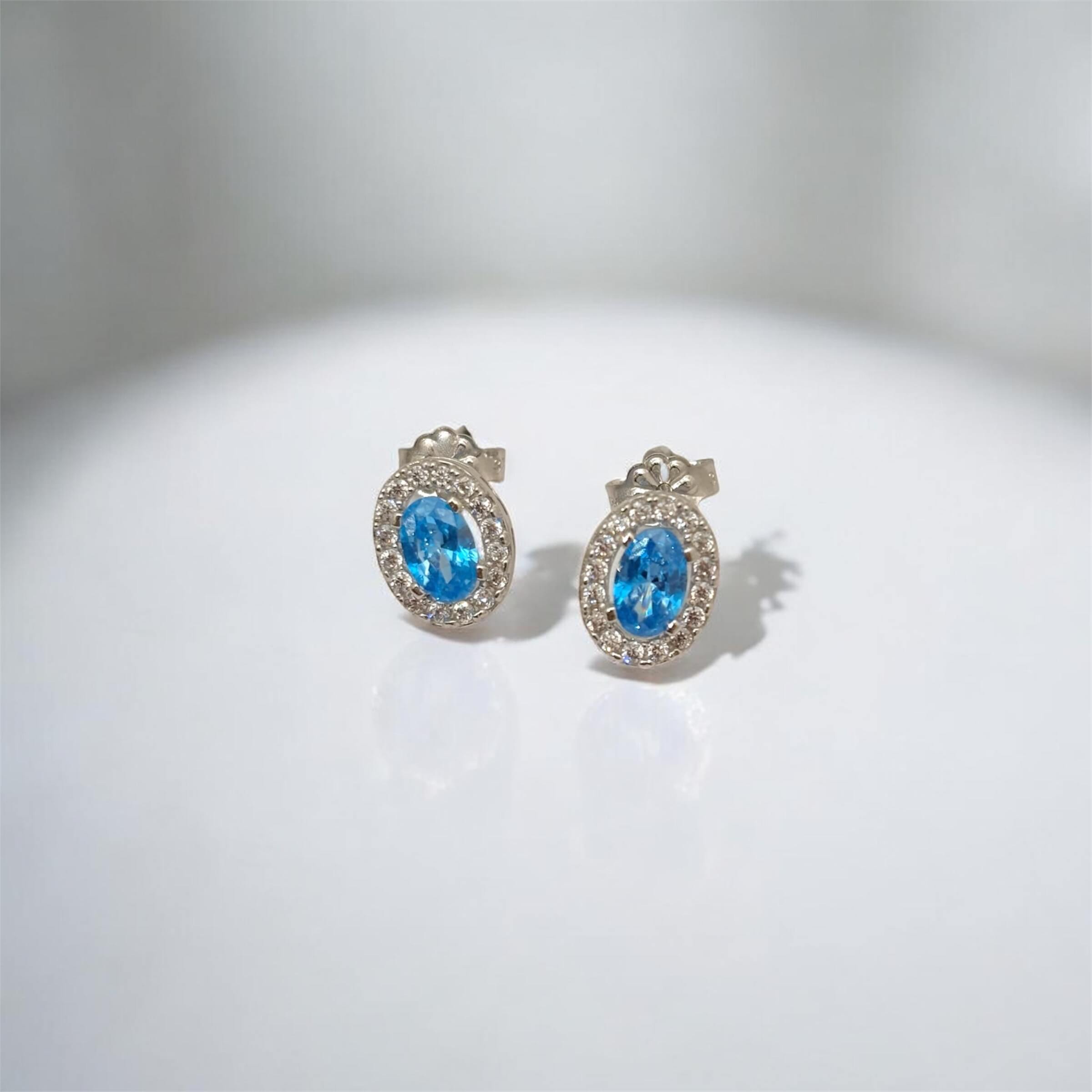 Λευκόχρυσα σκουλαρίκια ροζέτες πάνω στο αυτί με γαλάζιες πέτρες ζιργκόν , κ9